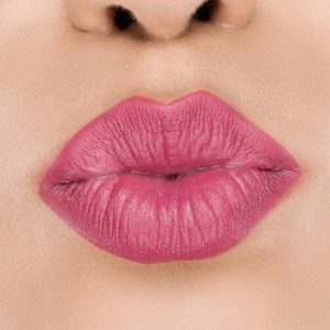 Raww - Coconut Kiss Lipstick in the shade of Berry Blaze with a closeup image applied to a woman's puckered lips