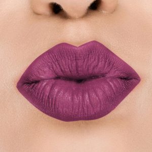 Raww - Coconut Kiss Lipstick in the shade of Bruised Blackberry with a closeup image applied to a woman's puckered lips