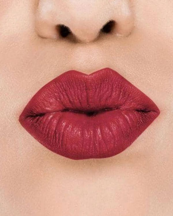 Raww - Coconut Kiss Lipstick in the shade of Candy Apple with a closeup image applied to a woman's puckered lips