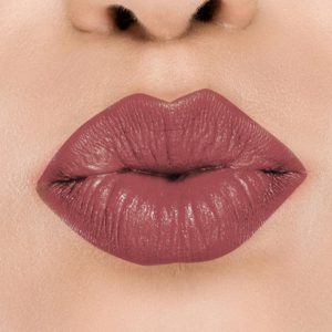Raww - Coconut Kiss Lipstick in the shade of Playful Plum with a closeup image applied to a woman's puckered lips