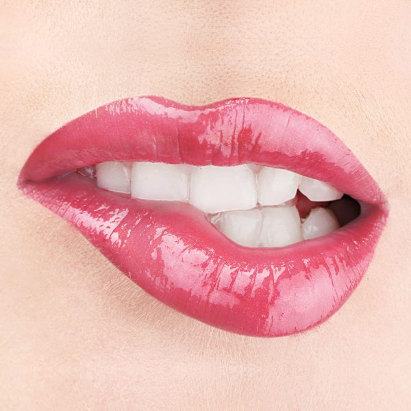Raww - Coconut Splash Lip Gloss in the shade of Short Shorts closeup image on a woman's lips