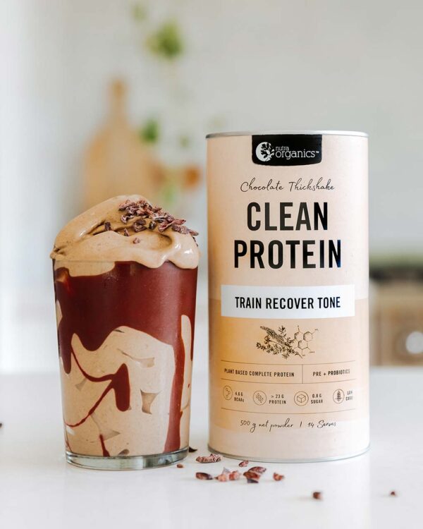 Nutra Organics Clean Protein Chocolate Thickshake Flavour Smoothie with product container on a kitchen table