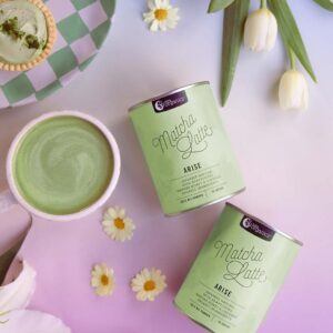 Styled image of Nutra Organics Matcha Latte drink and product containers on a colourful background