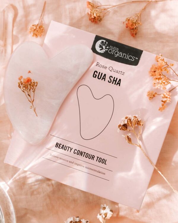 Nutra Organics Rose Quartz Gua Sha Beauty Contour Tool and packaging in a styled image