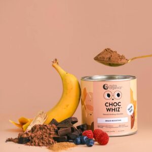 A stylized image of a can of Nutra Organics Choc Whiz natural drinking chocolate for kids placed beside an arrangement of a banana, raspberries, blueberries, chocolate powder, and chocolate pieces